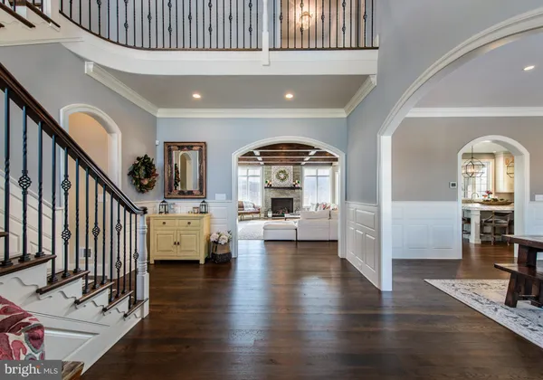 a view of livingroom with furniture staircase and kitchen view
