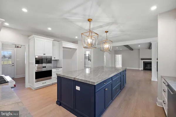 a kitchen with kitchen island granite countertop a large counter top and stainless steel appliances