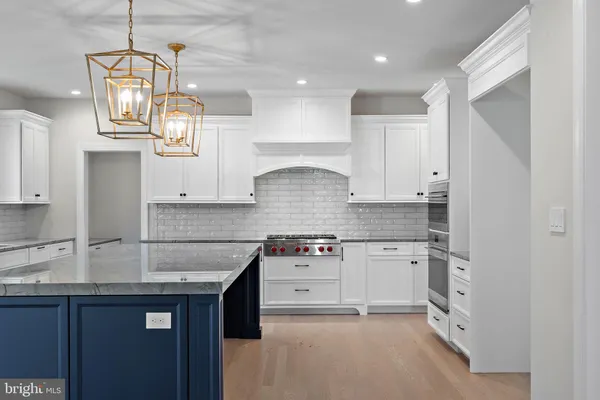 a kitchen with granite countertop a sink stainless steel appliances and cabinets