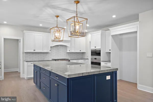 a kitchen with center island cabinets and stainless steel appliances