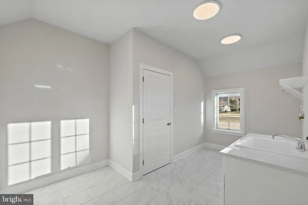 a view of a bathroom with two sink and a window