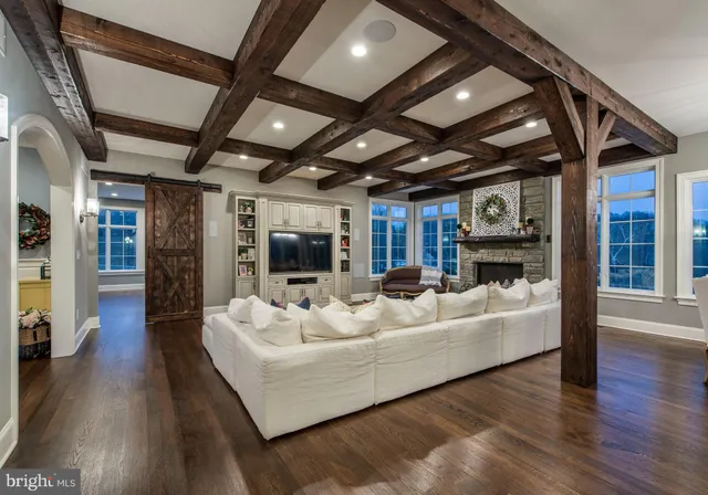 a dining hall with stainless steel appliances granite countertop a stove and cabinets with wooden floor