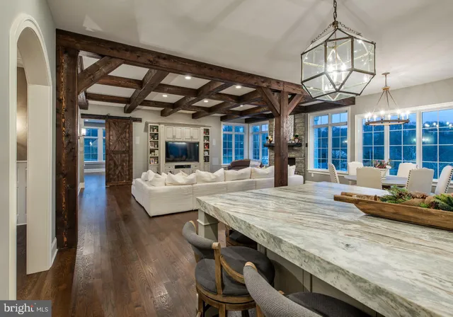 a kitchen with a stove and wooden floor