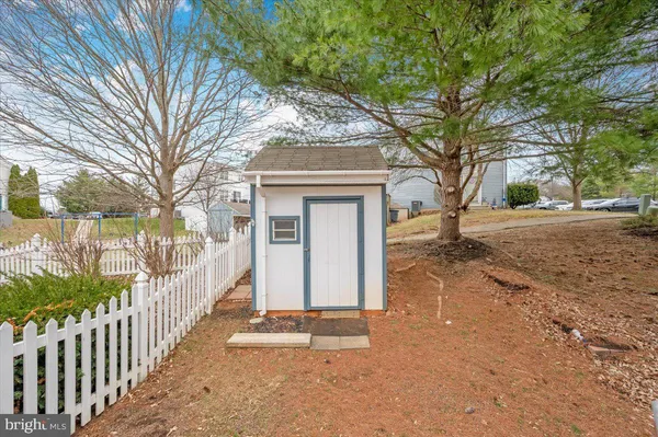 a view of a house with a yard covered in the background