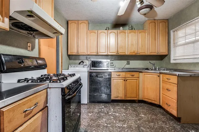 a kitchen with a stove a sink and a refrigerator