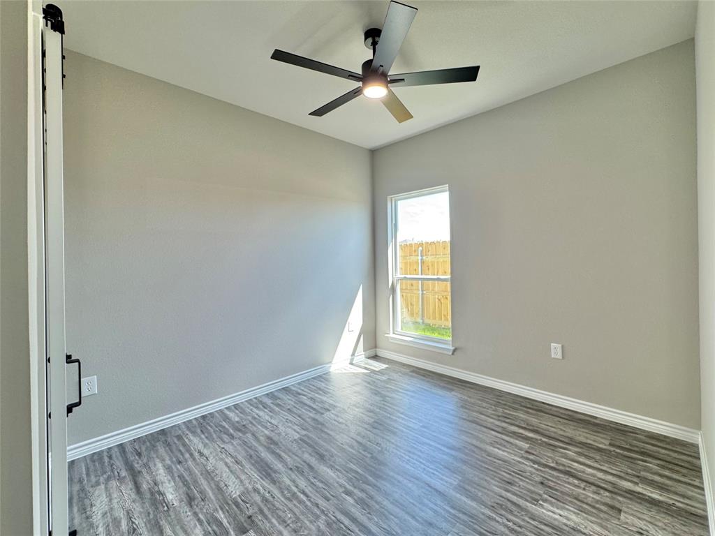 300 Rike Road Mabank, TX 75147 - Photo 15 of 18 wooden floor in an empty room with a window