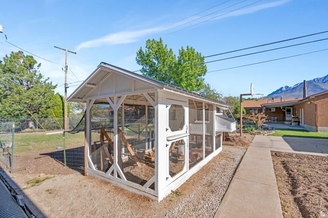 377 North 650 East, Unit 9 Orem, UT 84097 - Photo 4 of 9 Freestanding white wood-frame structure with a pitched roof and wire mesh enclosures