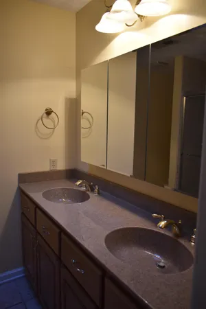 a bathroom with a granite countertop sink and a mirror