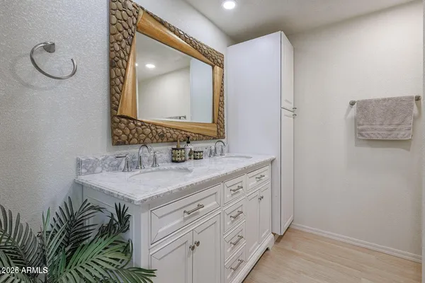 a bathroom with a sink a vanity and a mirror