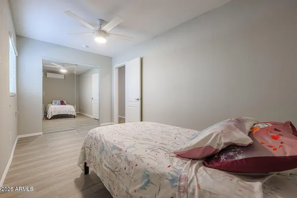 a bedroom with a bed and a closet