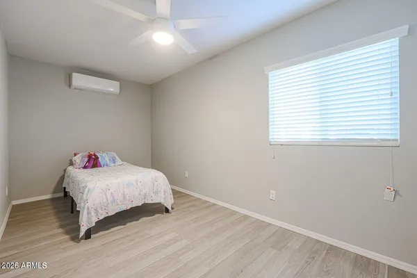 a bedroom with a bed and a window