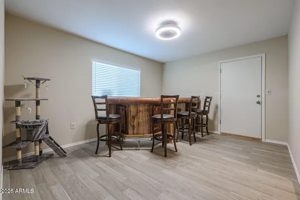 a view of a workspace with furniture and wooden floor