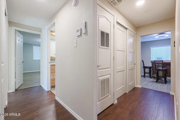 a view of a livingroom with wooden floor and furniture