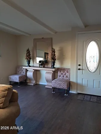 a living room with furniture and a large mirror