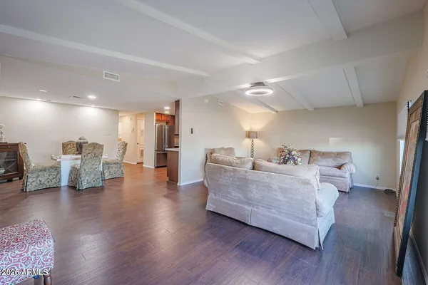 a living room with furniture and a wooden floor