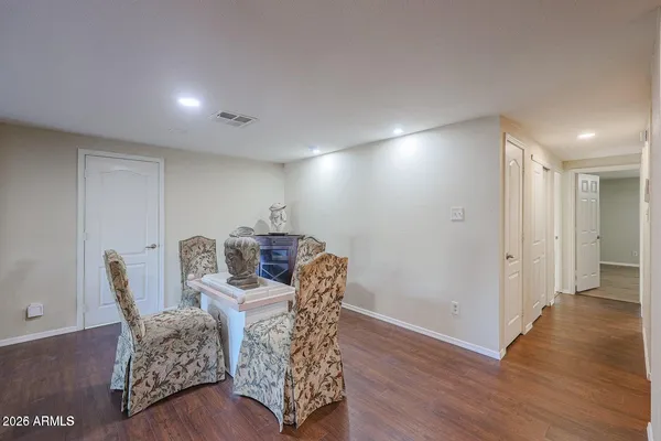a dining room with furniture and wooden floor