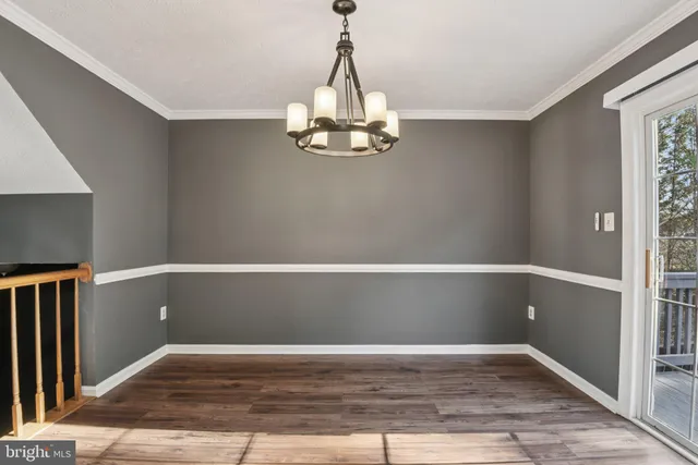 a view of a room with wooden floor and fan