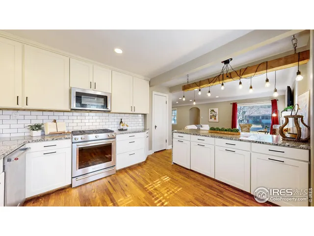 a kitchen with white cabinets a sink and white appliances