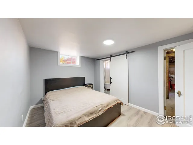 a living room with a bed furniture and a window