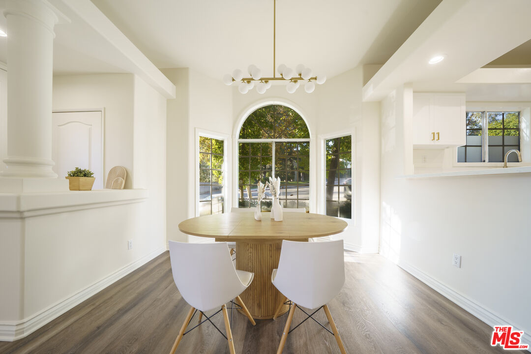4520 Pennsylvania Avenue, Unit 119 La Crescenta, CA 91214 - Photo 3 of 13 a dining room with furniture a chandelier and wooden floor