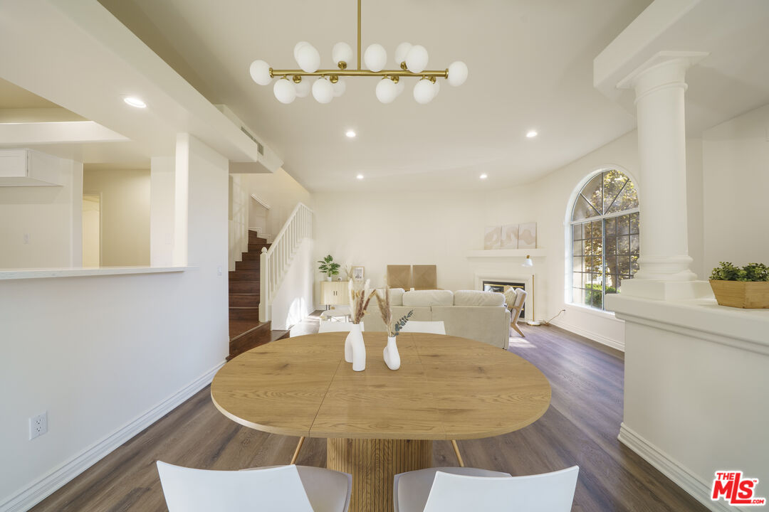 4520 Pennsylvania Avenue, Unit 119 La Crescenta, CA 91214 - Photo 4 of 13 a dining room with wooden floor a chandelier a wooden table and chairs