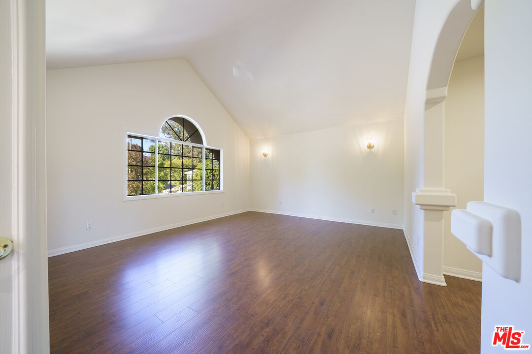 4520 Pennsylvania Avenue, Unit 119 La Crescenta, CA 91214 - Photo 7 of 13 an empty room with wooden floor cabinet and windows