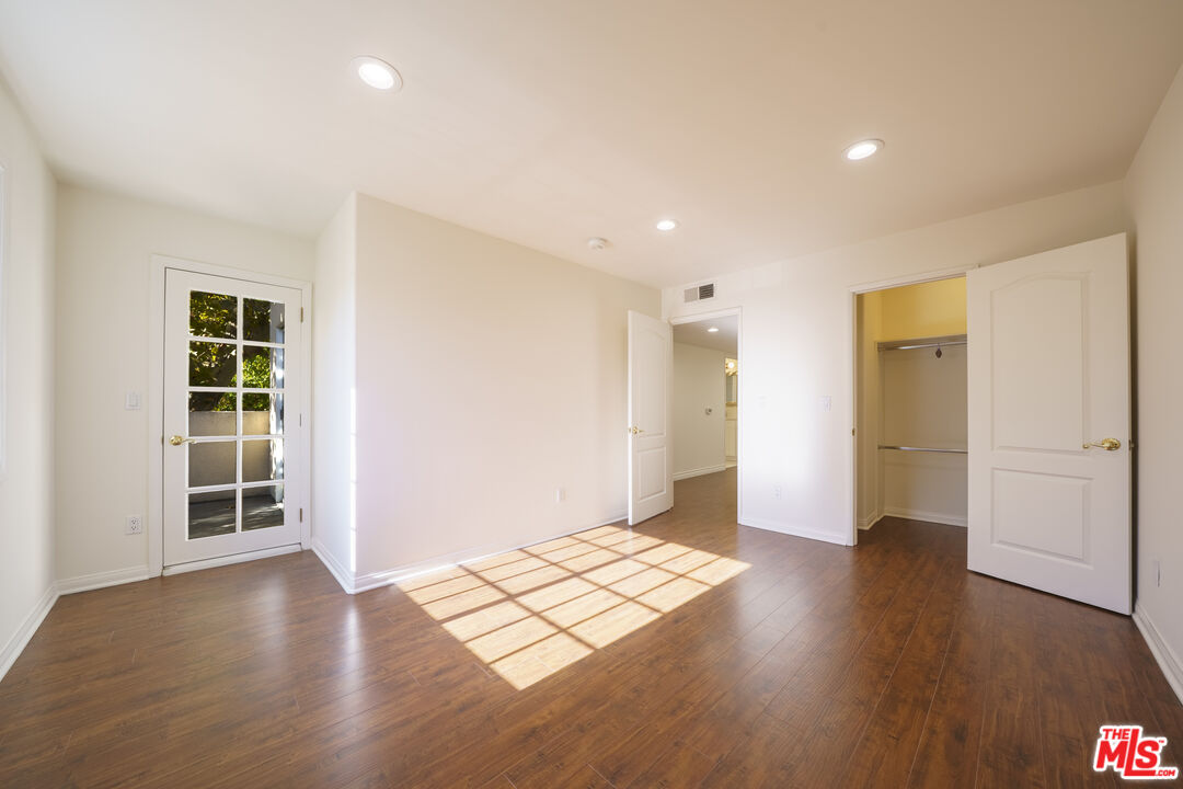 4520 Pennsylvania Avenue, Unit 119 La Crescenta, CA 91214 - Photo 8 of 13 an empty room with wooden floor and windows