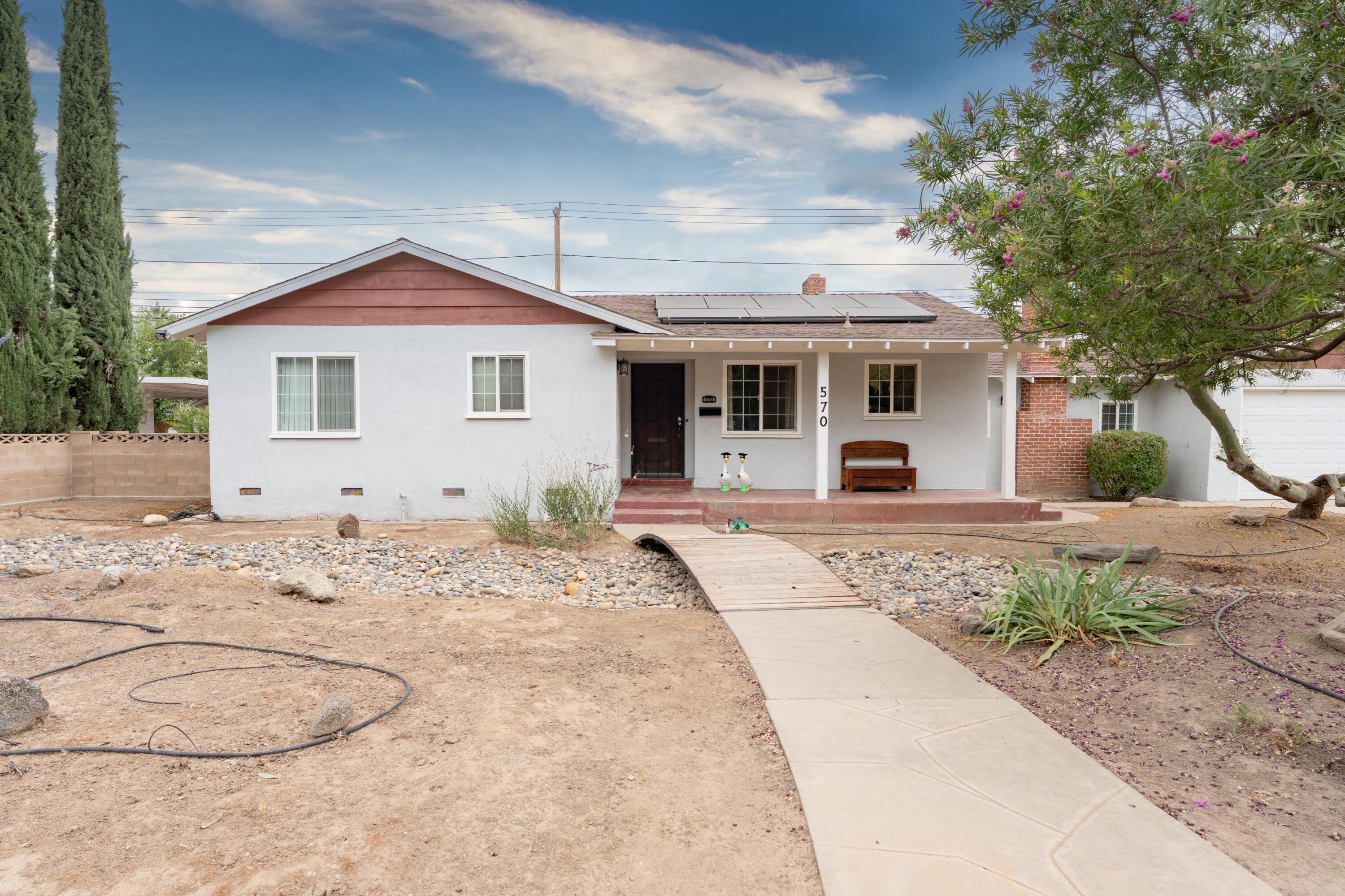 570 North Birch Avenue Reedley, CA 93654 - Photo 3 of 52 a front view of a house with a yard