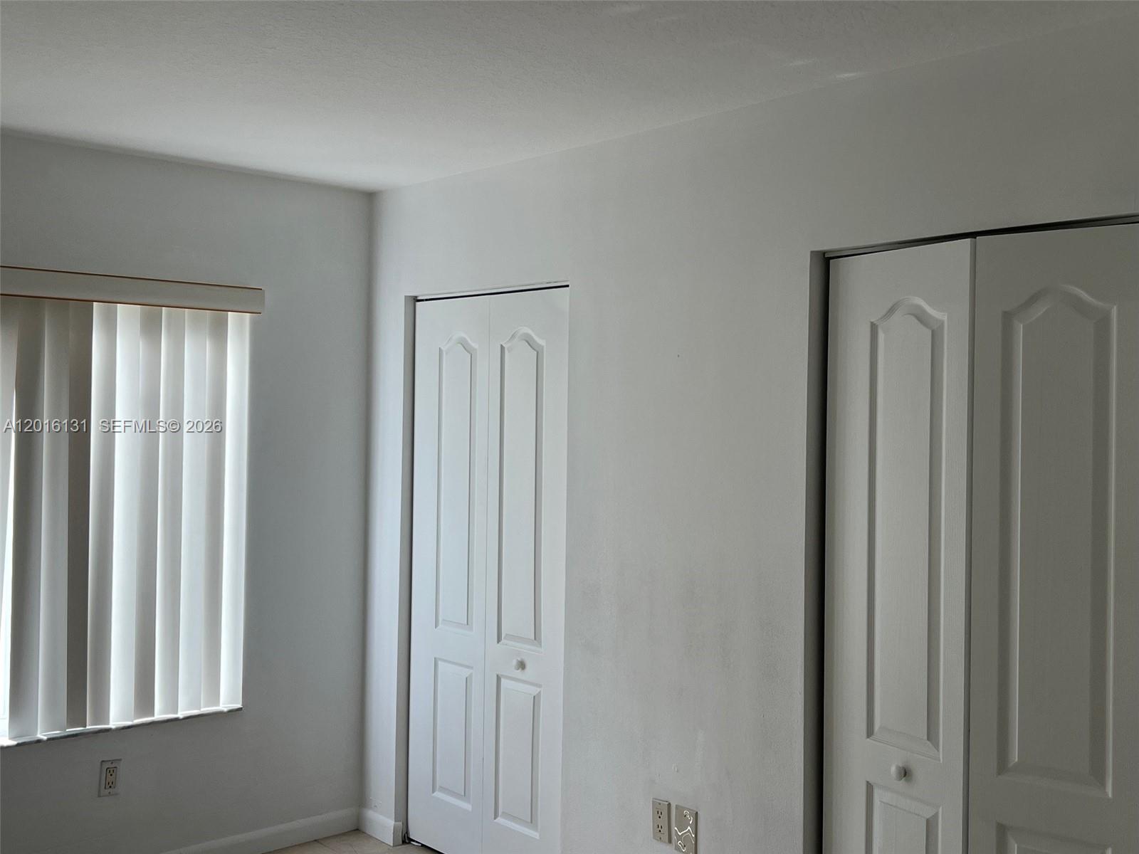 12605 Southwest 91st Street, Unit 103 Miami, FL 33186 - Photo 11 of 14 a view of a closet area with windows