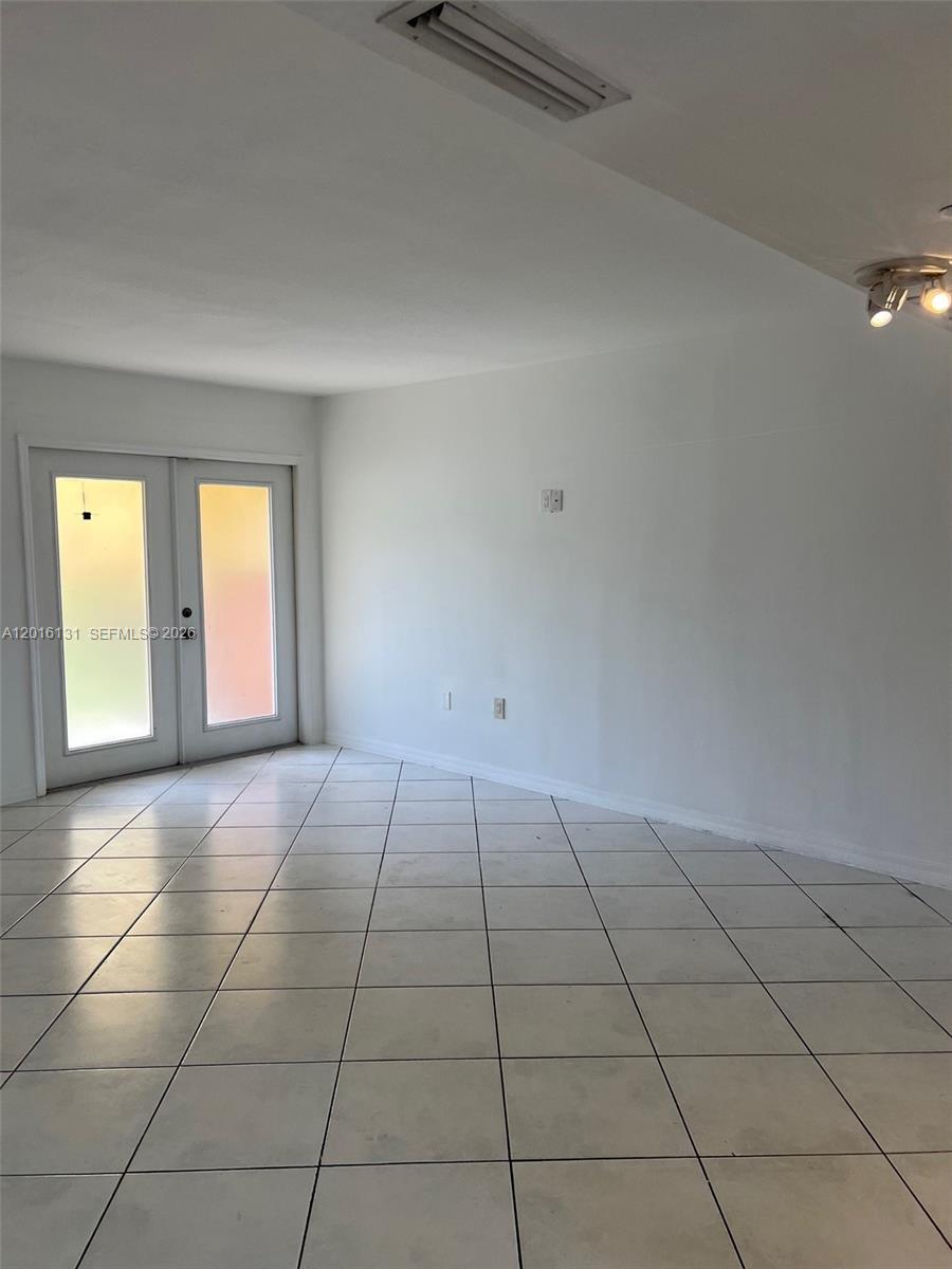 12605 Southwest 91st Street, Unit 103 Miami, FL 33186 - Photo 14 of 14 a view of an empty room with a window