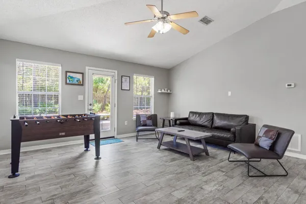 a kitchen with stainless steel appliances granite countertop a sink stove refrigerator and cabinets
