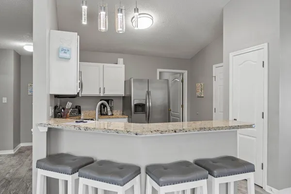 a kitchen with a refrigerator stove and sink