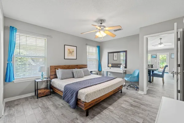 a spacious bathroom with a double vanity sink a toilet and a large mirror