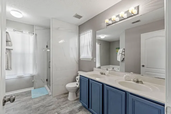 a white bath tub sitting next to a shower