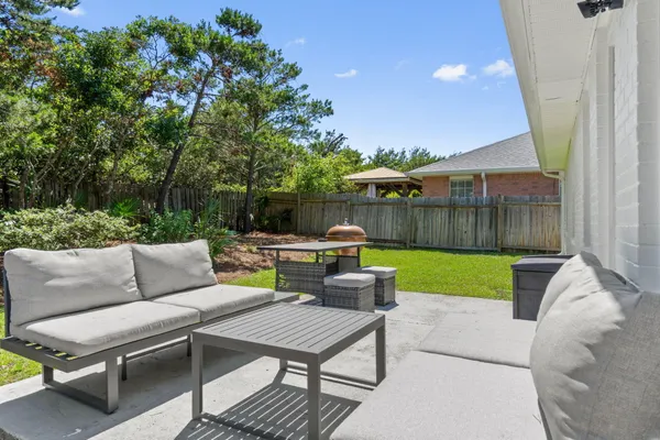 a view of a house with a yard and potted plants