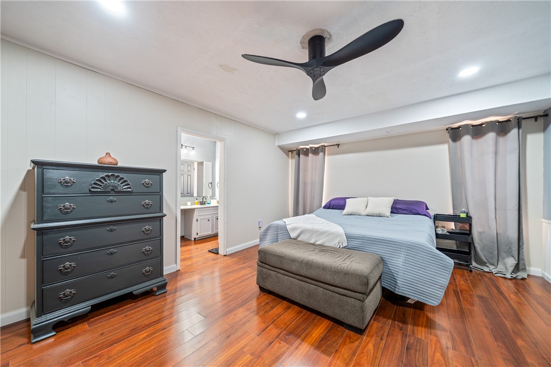 2217 Post Oak Drive Portland, TX 78374 - Photo 18 of 39 a bedroom with a bed and wooden floor
