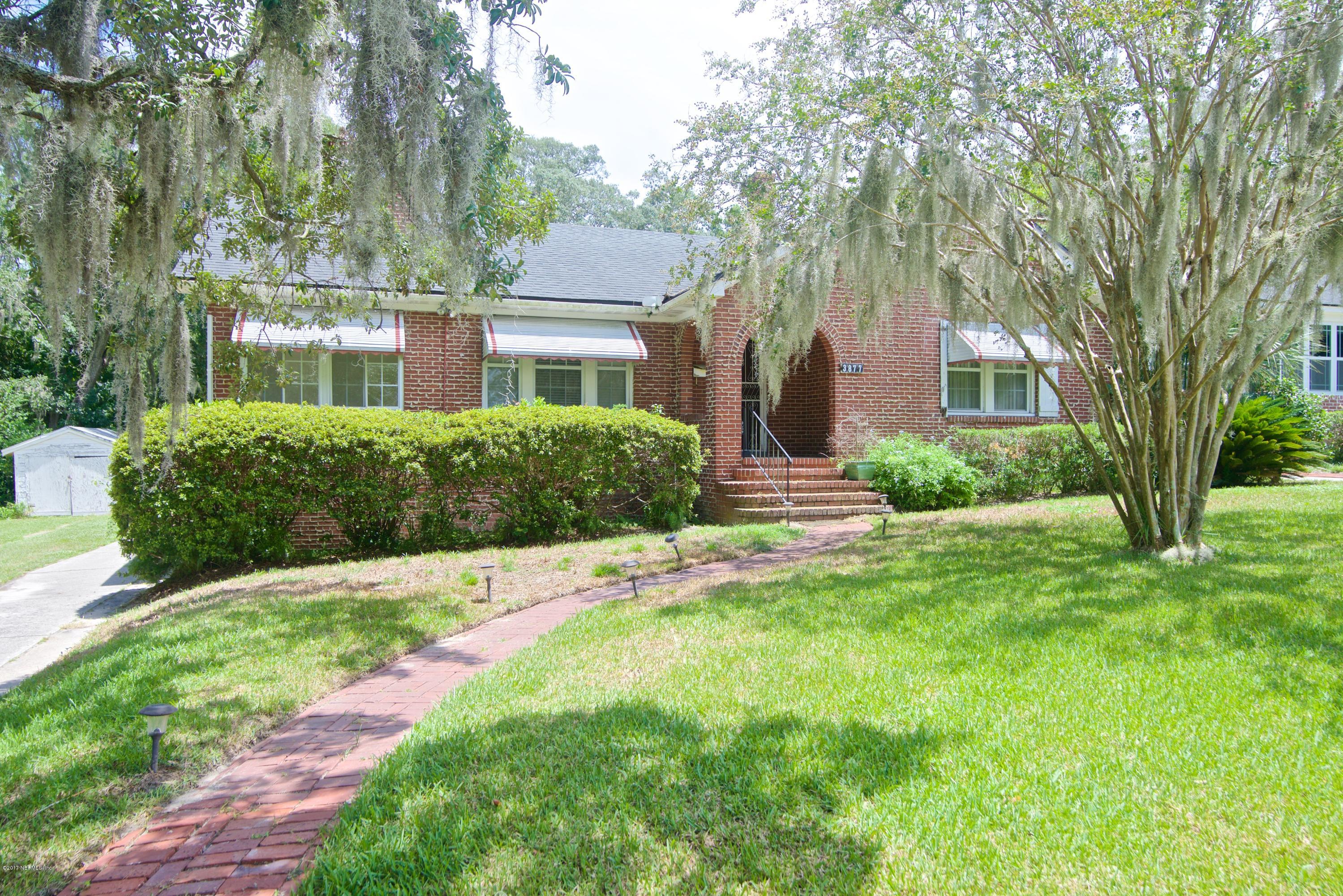 3877 Gadsden Road Jacksonville, FL 32207 - Photo 1 of 24 a front view of a house with a yard and large trees