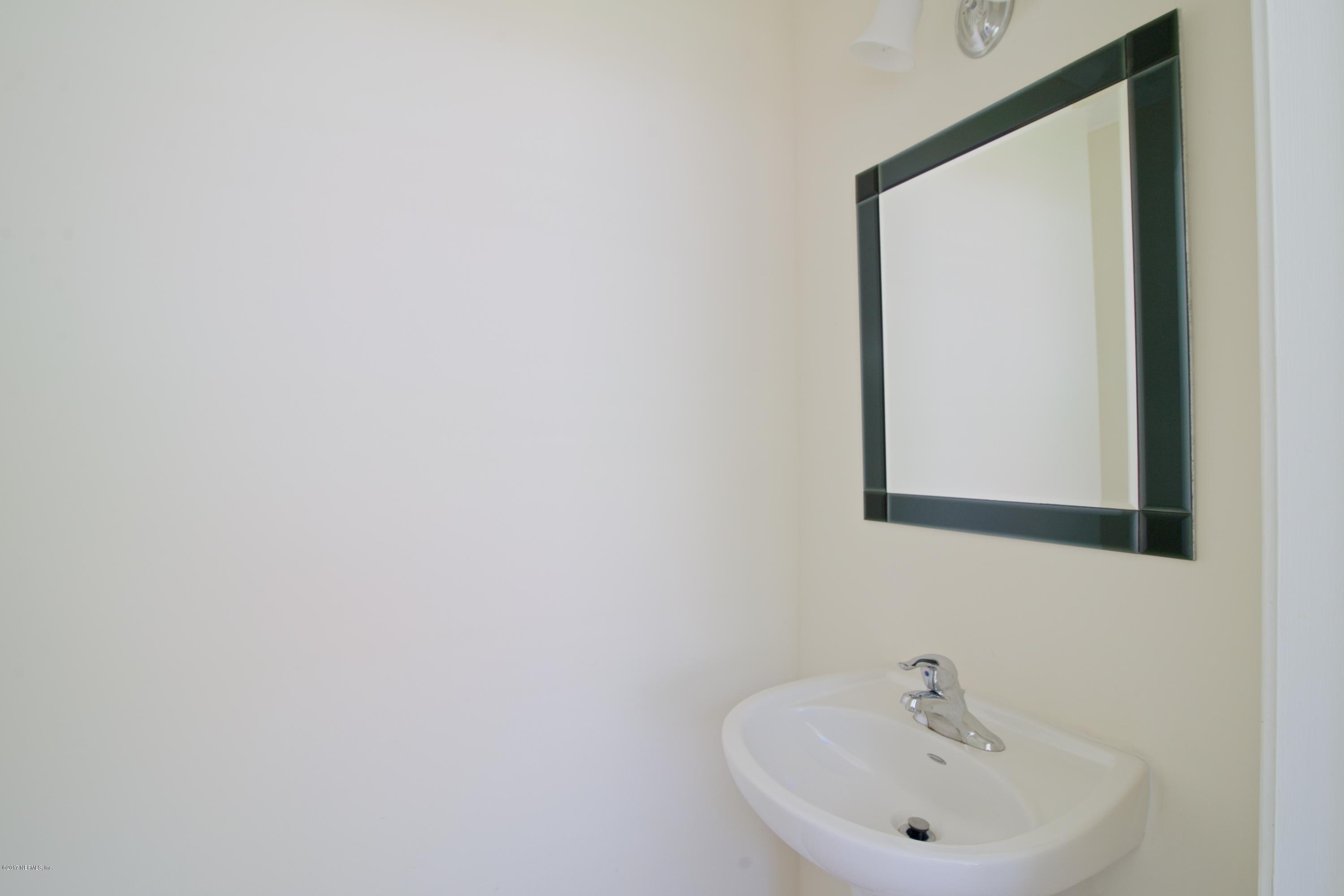 3877 Gadsden Road Jacksonville, FL 32207 - Photo 13 of 24 a bathroom with a sink and a mirror