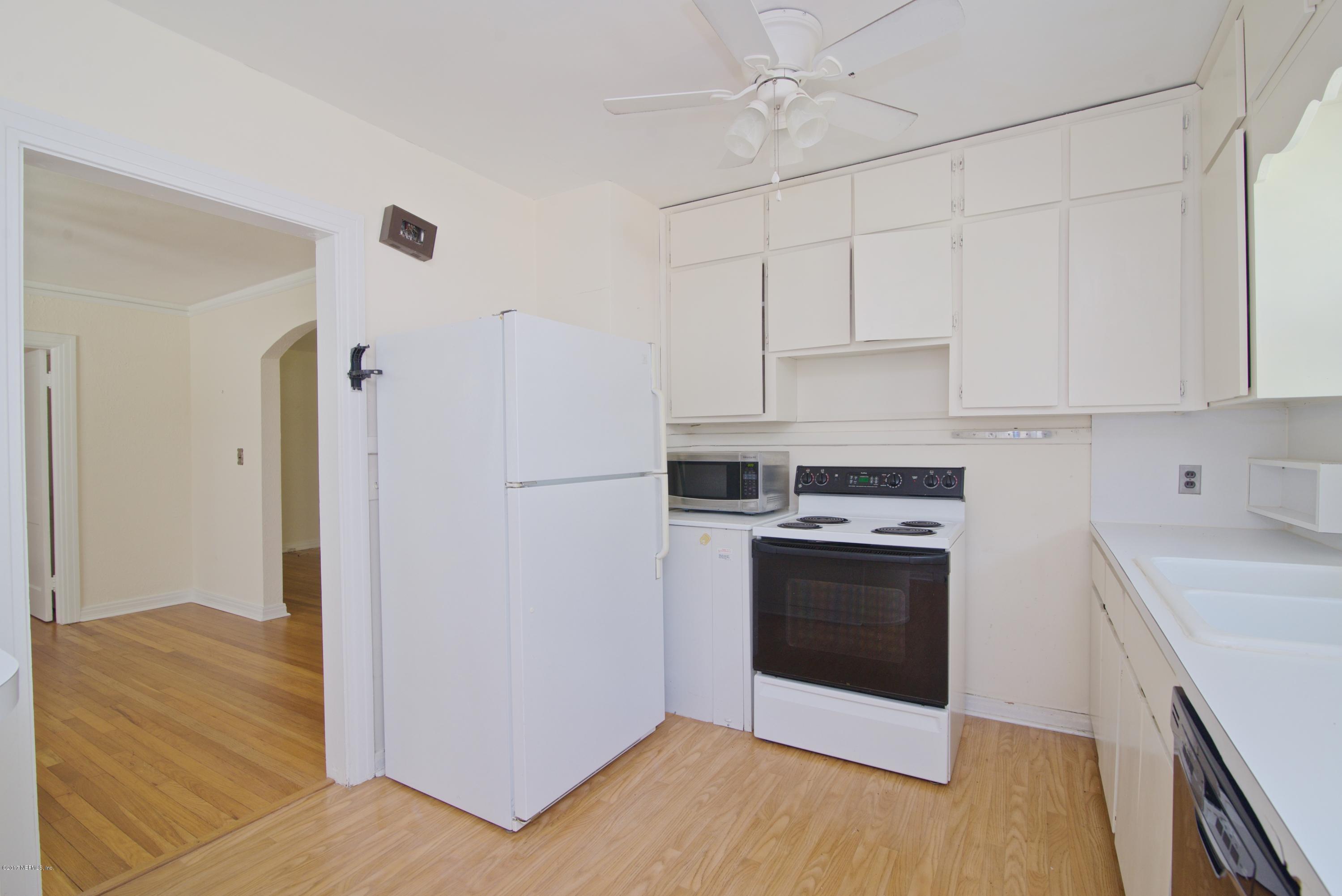 3877 Gadsden Road Jacksonville, FL 32207 - Photo 16 of 24 a kitchen with stainless steel appliances white cabinets and a refrigerator