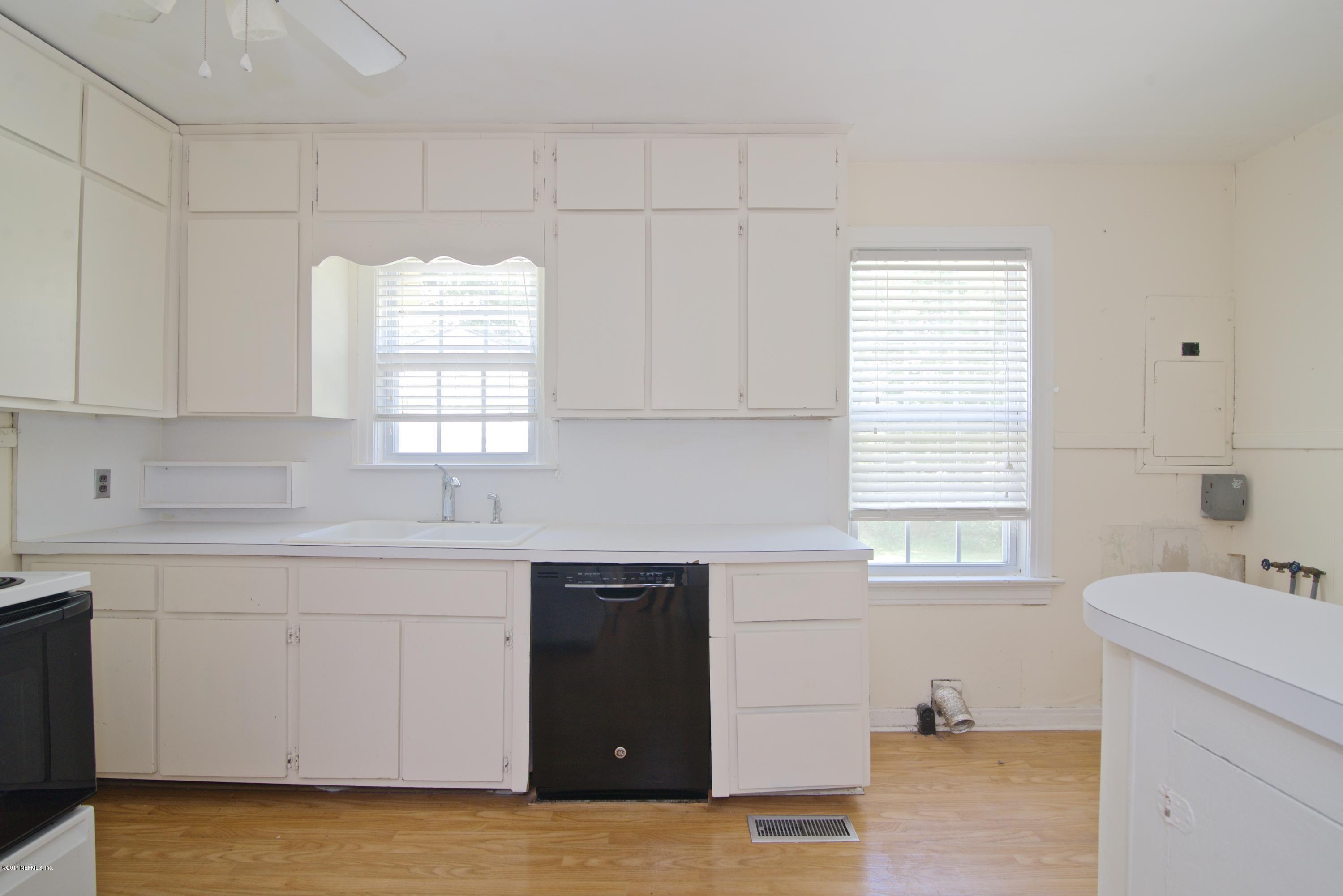 3877 Gadsden Road Jacksonville, FL 32207 - Photo 18 of 24 a kitchen with a sink window and cabinets