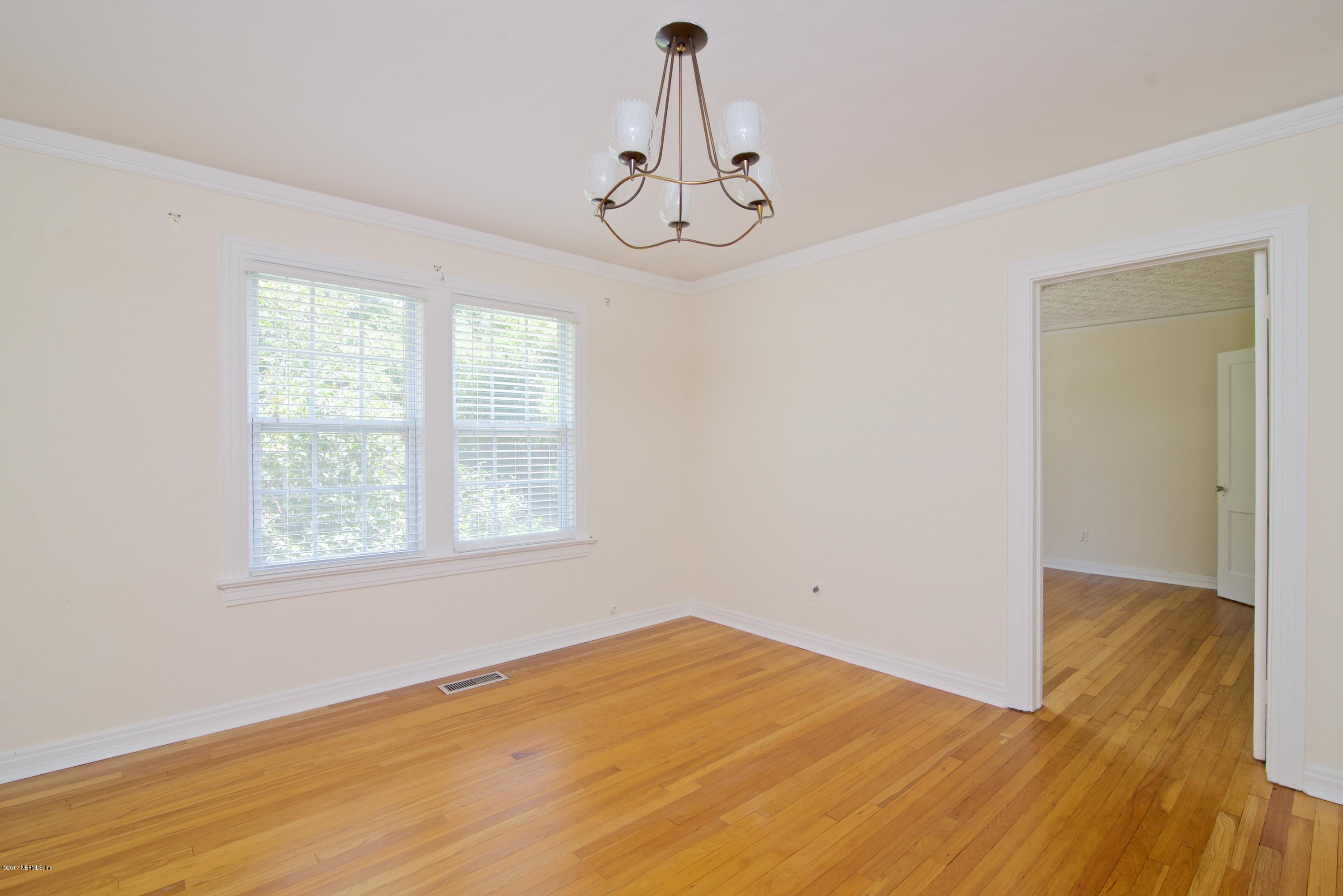 3877 Gadsden Road Jacksonville, FL 32207 - Photo 7 of 24 a view of empty room with wooden floor and fan