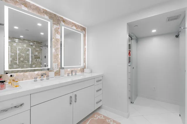a bathroom with a shower sink and mirror
