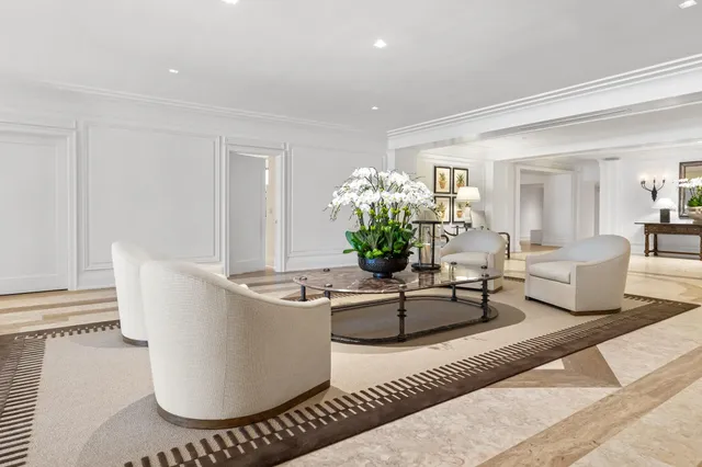 a living room with furniture and flowers