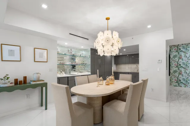a view of a dining room with furniture a chandelier and wooden floor