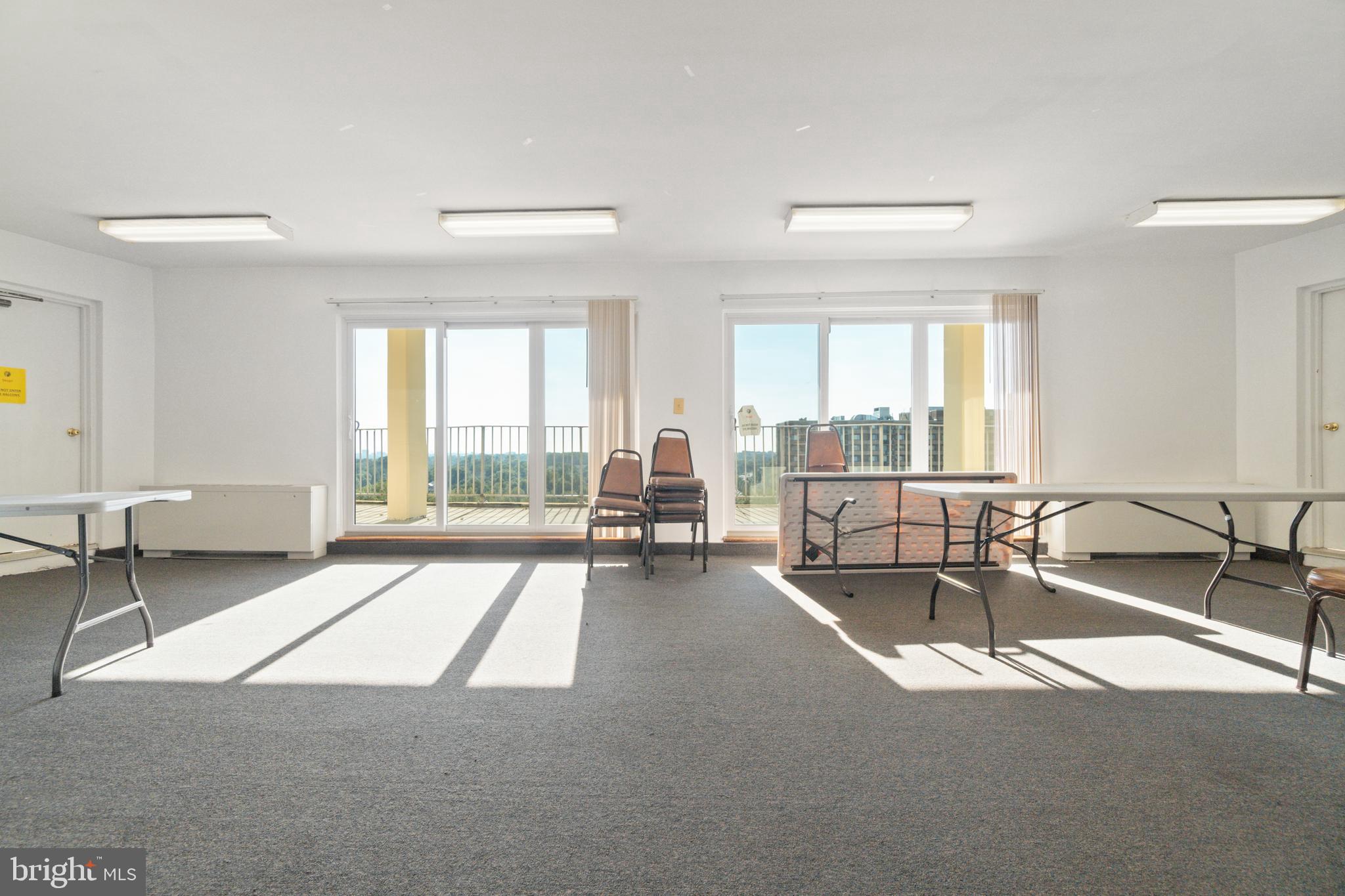 1111 University Boulevard West, Unit 813A Silver Spring, MD 20902 - Photo 18 of 22 a living room with furniture and large windows