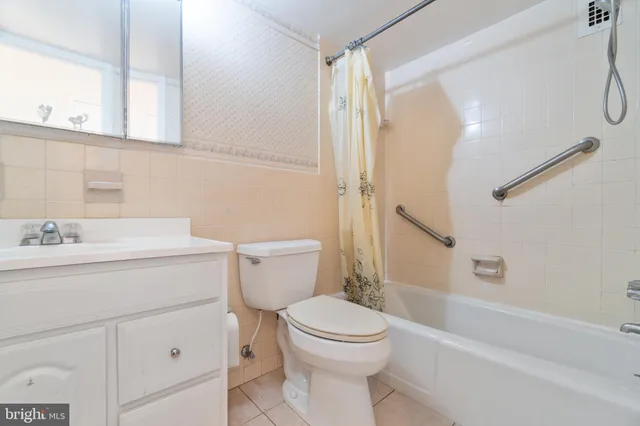 a bathroom with a sink a mirror toilet and bathtub