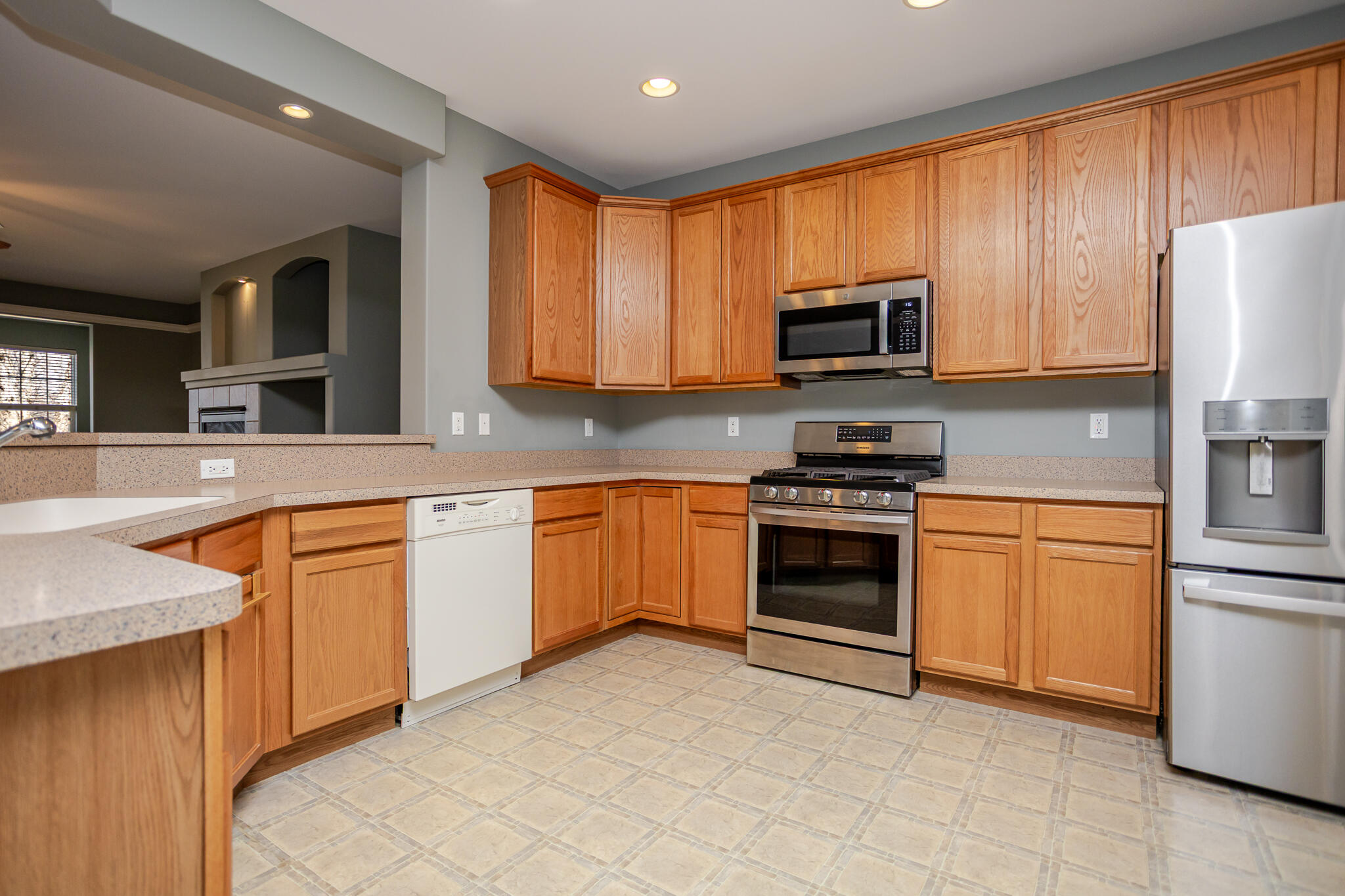 350 Cochran Drive Crown Point, IN 46307 - Photo 8 of 37 a kitchen with stainless steel appliances granite countertop a stove top oven a sink dishwasher and a refrigerator with wooden cabinets