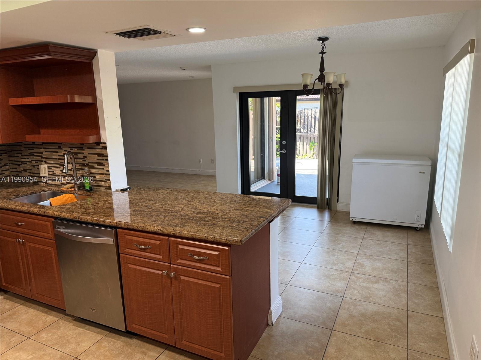 4825 Southwest 149th Court, Unit 18B Miami, FL 33185 - Photo 13 of 36 a kitchen with stainless steel appliances granite countertop a refrigerator and a sink