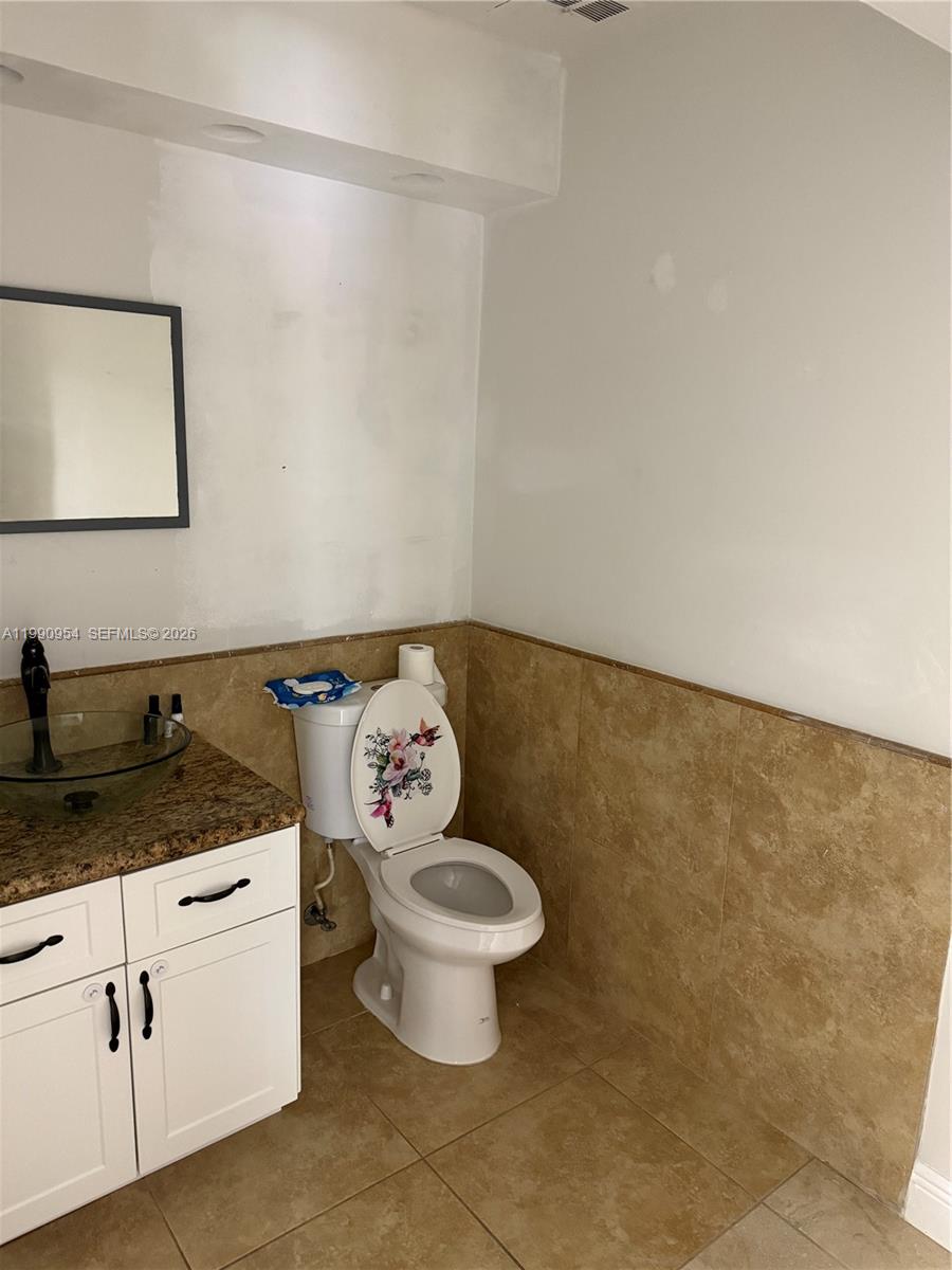4825 Southwest 149th Court, Unit 18B Miami, FL 33185 - Photo 17 of 36 a bathroom with a granite countertop sink and a toilet
