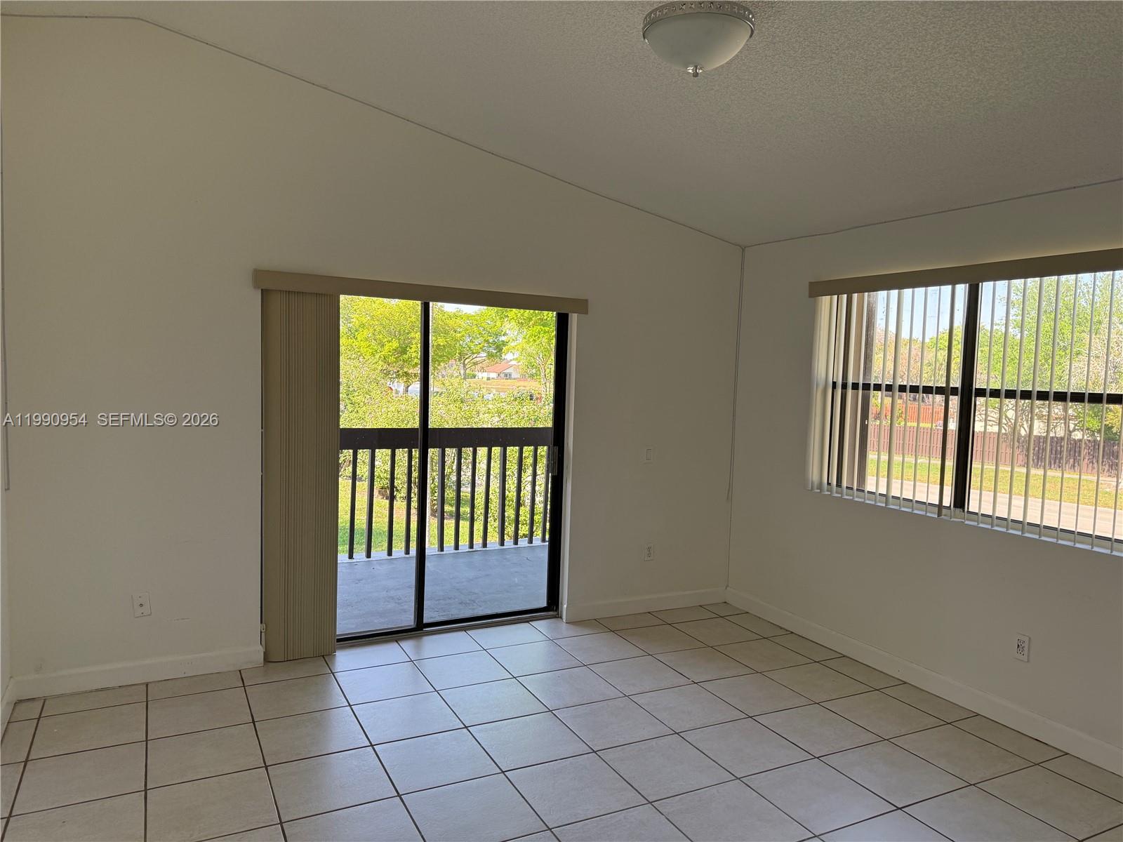 4825 Southwest 149th Court, Unit 18B Miami, FL 33185 - Photo 22 of 36 an empty room with windows